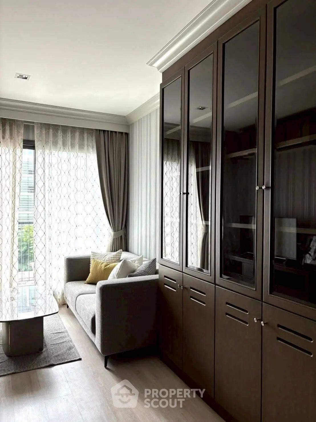 Stylish living room with elegant cabinetry and cozy sofa in modern apartment