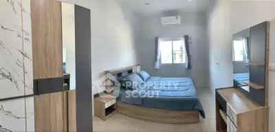 Modern bedroom with stylish wooden furniture and air conditioning