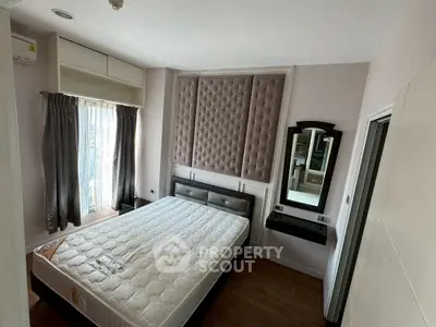 Modern bedroom with stylish padded wall and natural light