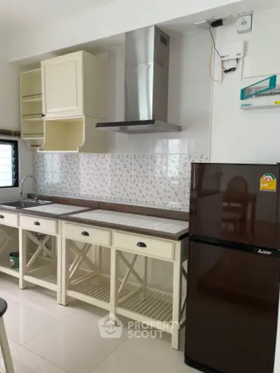 Bright and airy kitchen space featuring modern appliances, ample cabinetry, and elegant tile backsplash, perfect for culinary enthusiasts.