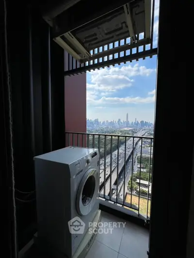 High-rise balcony with washing machine and stunning city skyline view