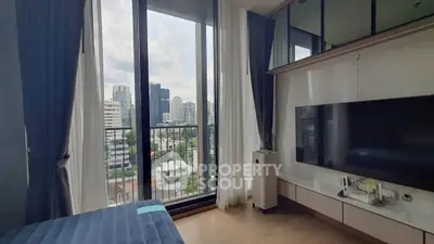 Modern bedroom with city view and floor-to-ceiling windows