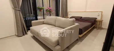 Modern bedroom with cozy sofa and elegant decor