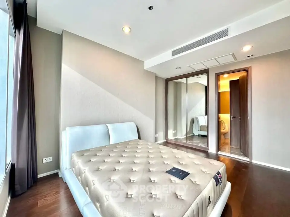 Spacious modern bedroom with large windows and elegant decor