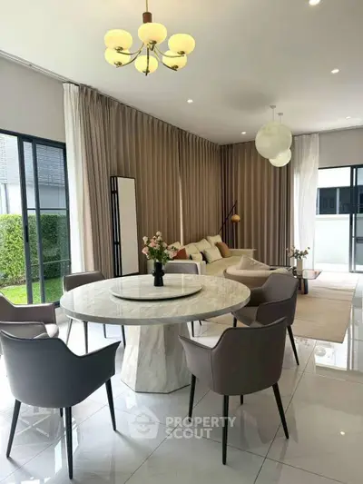 Elegant living room with modern furniture and large windows for natural light.