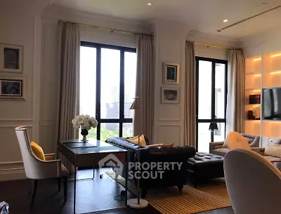 Luxurious living room with elegant decor and city view, featuring plush seating and stylish lighting.