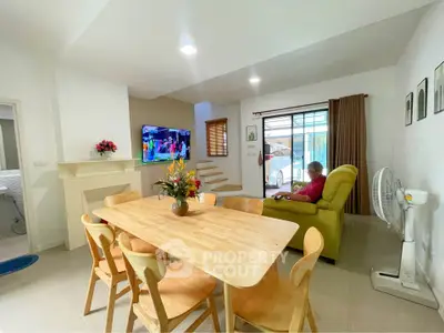 Spacious living room with modern dining area and cozy seating, perfect for family gatherings.