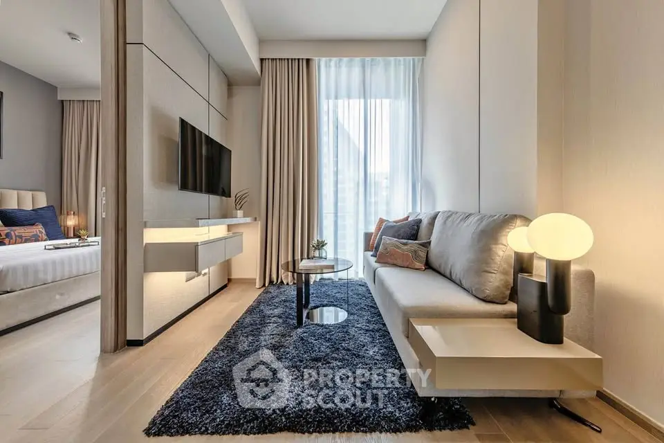 Modern living room with sleek design, cozy sofa, and stylish decor adjacent to a bedroom.
