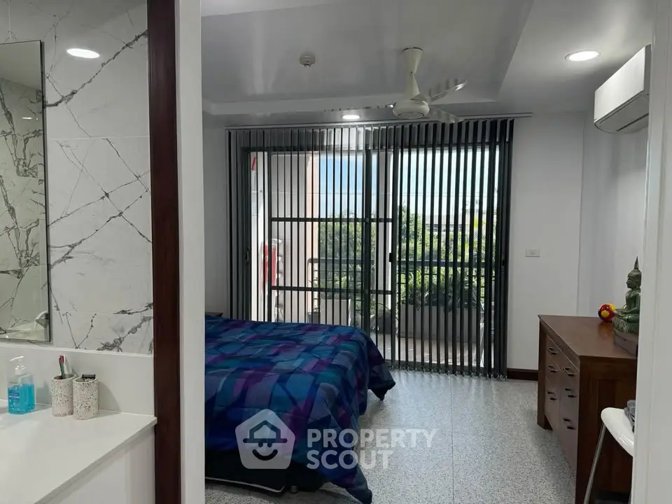 Modern bedroom with balcony access and stylish decor