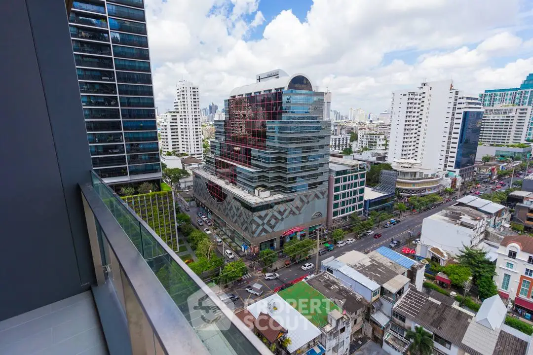Stunning cityscape view from a high-rise balcony in a bustling urban area.