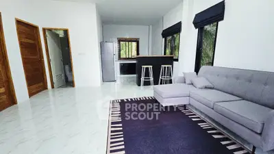 Spacious modern living room with open kitchen and stylish decor