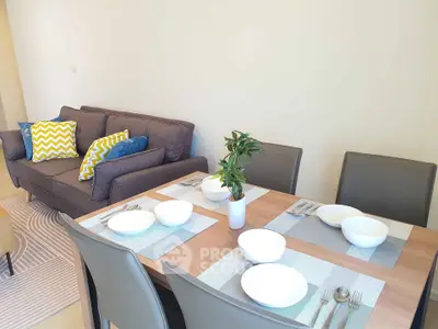 Modern living room with stylish dining area and cozy sofa, perfect for entertaining guests.