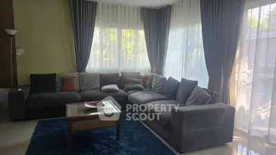 Spacious living room with large sectional sofa and natural light