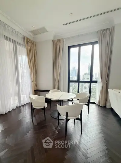 Elegant dining area with city view, featuring floor-to-ceiling windows and chic decor.