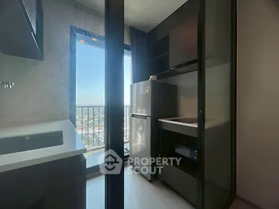 Modern kitchen with sleek design and city view from balcony