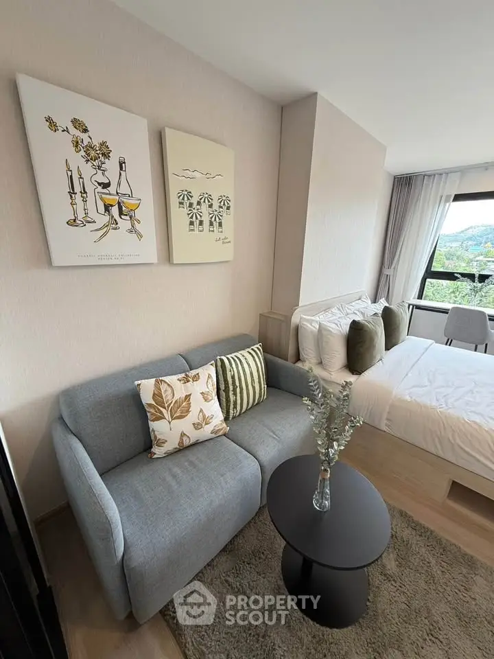 Chic modern studio with cozy living area and scenic window view