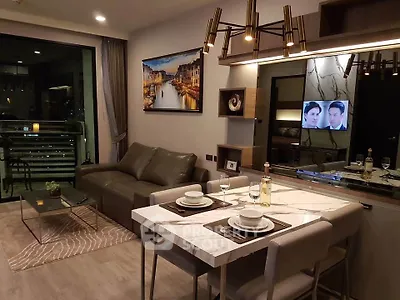 Modern living room with elegant dining area and city view balcony.
