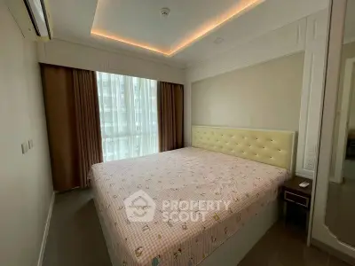 Cozy bedroom with large window and modern lighting in a stylish apartment.