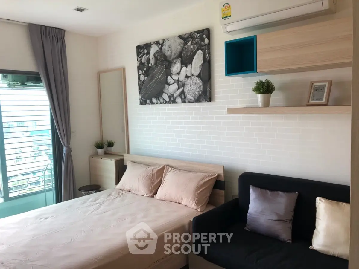 Modern bedroom with stylish decor and natural light, featuring a cozy bed and elegant shelving.