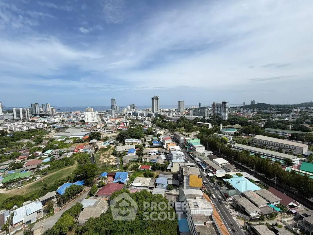 Stunning aerial view of urban landscape with high-rise buildings and lush greenery, perfect for real estate investment.