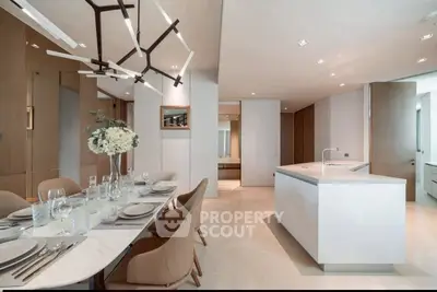 Luxurious modern kitchen and dining area with elegant lighting and sleek design.
