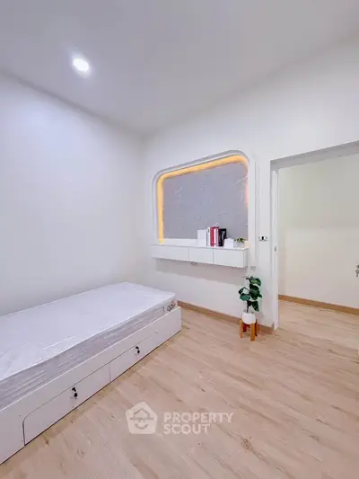 Modern minimalist bedroom with sleek design and built-in storage solutions.
