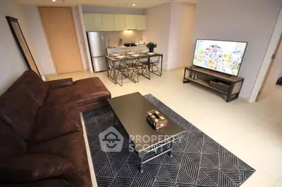 Modern open-plan living room with stylish kitchen and cozy seating area.