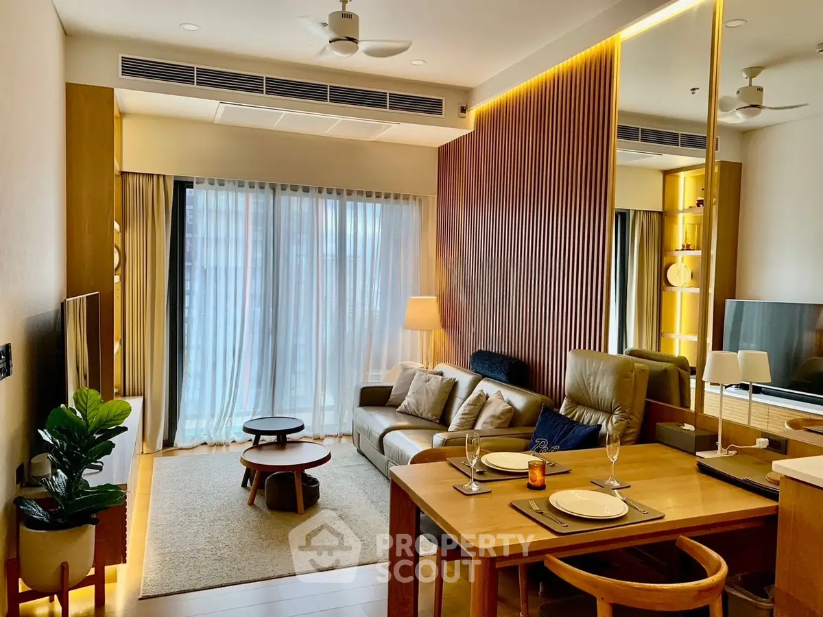 Modern living room with stylish decor and natural light, featuring a cozy seating area and dining space.