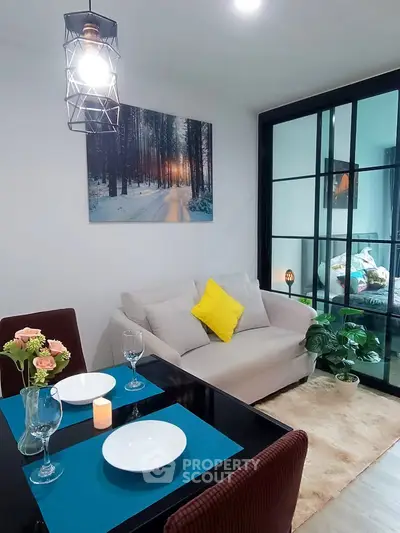 Chic living room with cozy sofa, dining area, and modern decor in a stylish apartment.