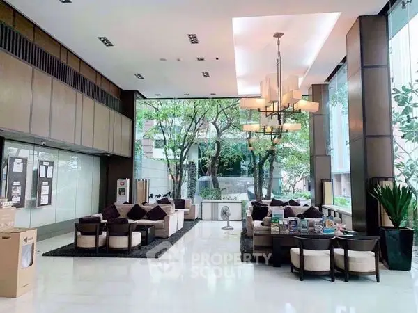 Luxurious modern lobby with elegant seating and large windows overlooking greenery.