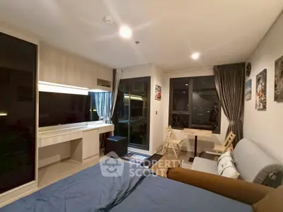 Modern studio apartment with city view, featuring cozy living area and stylish decor.