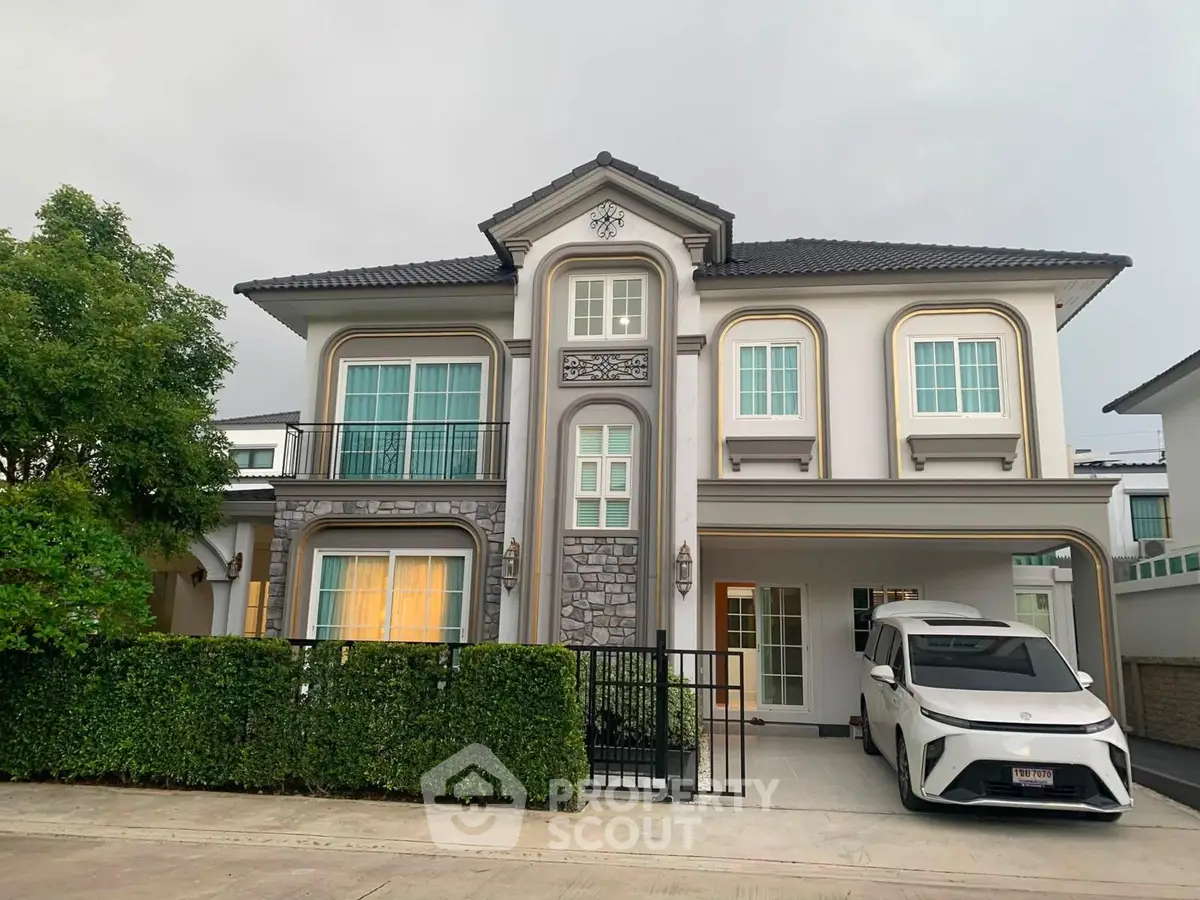 Elegant two-story house with modern design, large windows, and attached garage in a serene neighborhood.