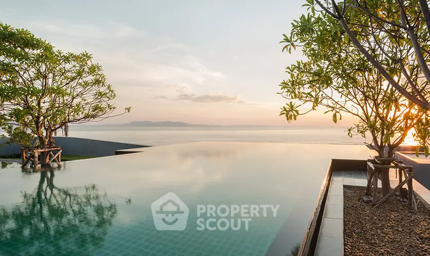Luxurious infinity pool with stunning ocean view at sunset, perfect for relaxation and leisure.