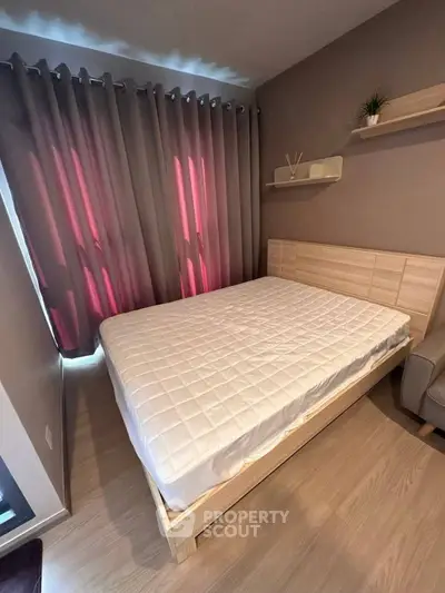 Cozy bedroom with modern decor and natural light, featuring a comfortable bed and stylish curtains.