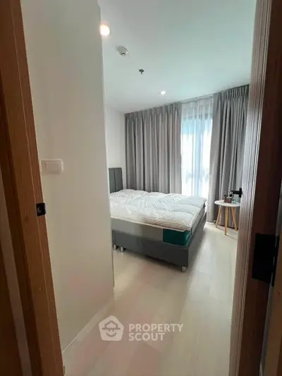 Cozy bedroom with natural light and modern decor in a stylish apartment.