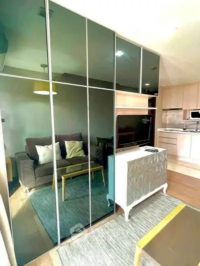 Modern living room with sleek mirrored cabinets and cozy seating area