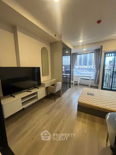 Modern studio apartment with sleek design and city view balcony