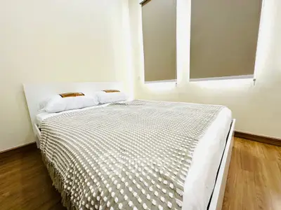 Spacious bedroom with modern decor and natural light