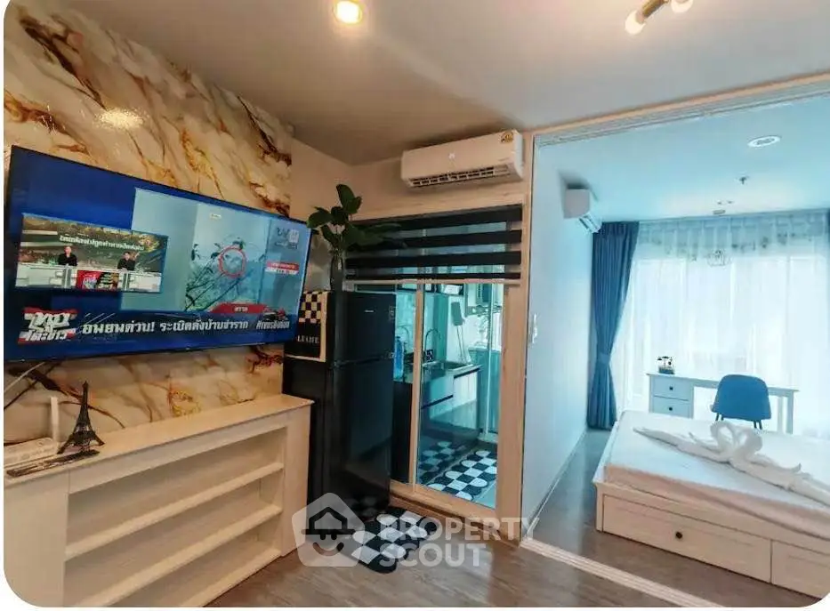 Modern apartment interior with open living room and bedroom, featuring stylish decor and natural light.