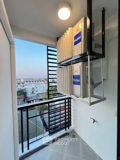 Modern balcony with city view and air conditioning units, perfect for urban living.