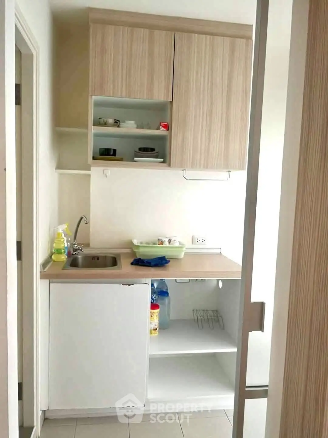 Compact kitchen with modern cabinetry and small sink, ideal for efficient space use.