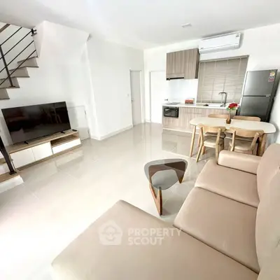 Modern open-plan living room with sleek kitchen and stylish furniture