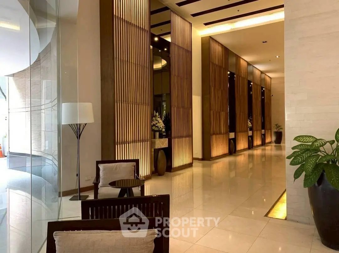 Luxurious modern lobby with elegant lighting and stylish decor, perfect for welcoming guests in a high-end building.