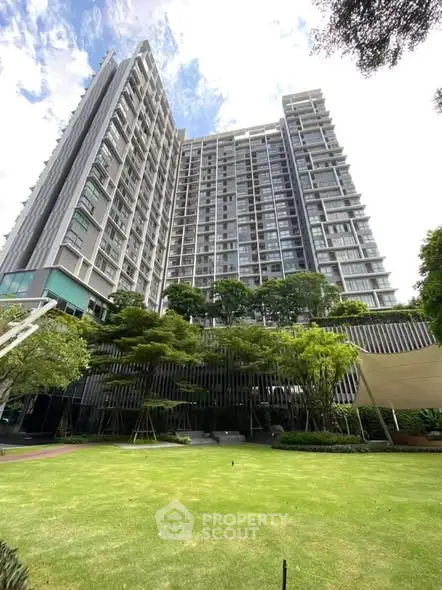 Stunning high-rise building with lush garden view, perfect for urban living.