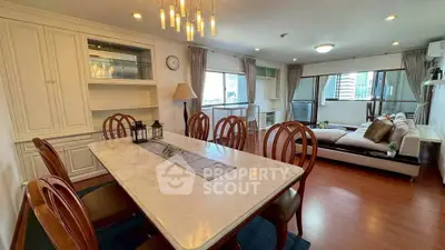 Spacious dining and living area with elegant decor and city view.
