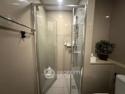 Modern bathroom with glass shower enclosure and stylish decor