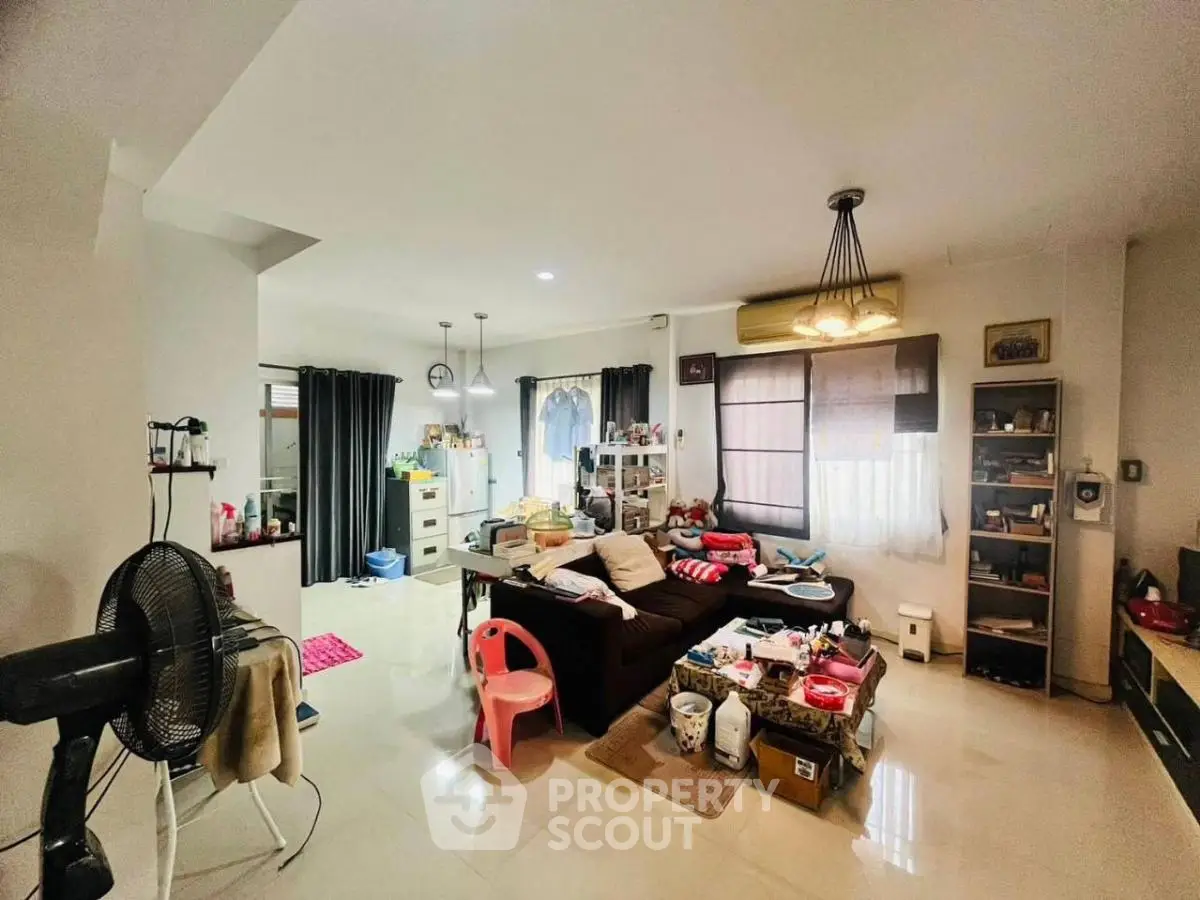 Spacious living room with modern decor and ample natural light