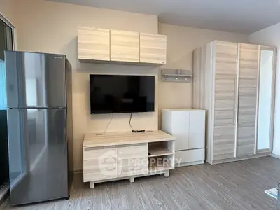 Modern living room with sleek wooden furniture and stainless steel fridge