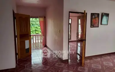 Spacious interior with tiled floors and balcony access, perfect for natural light and fresh air.