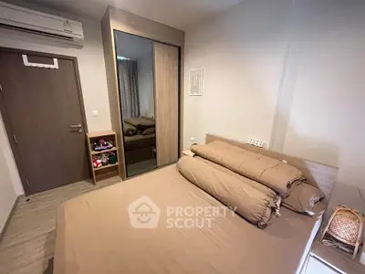 Cozy bedroom with modern wardrobe and air conditioning in a stylish apartment.